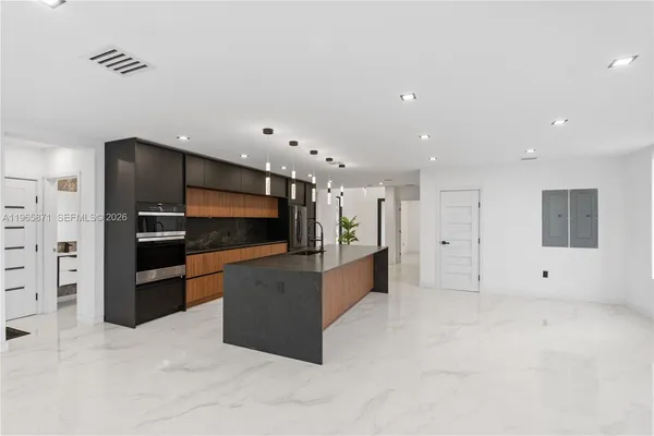 a view of kitchen with refrigerator and window