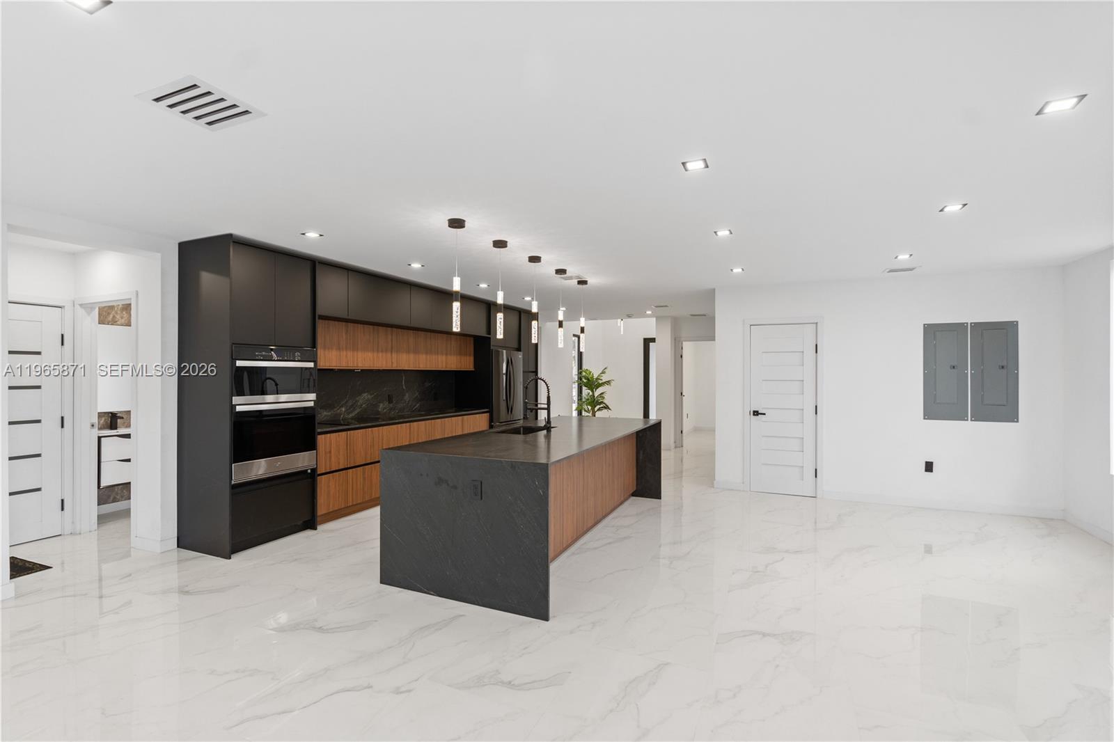 1644 Northwest 8th Terrace Miami, FL 33125 - Photo 9 of 60 a large kitchen with stainless steel appliances a large counter top