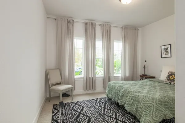 a bedroom with a large bed and a window