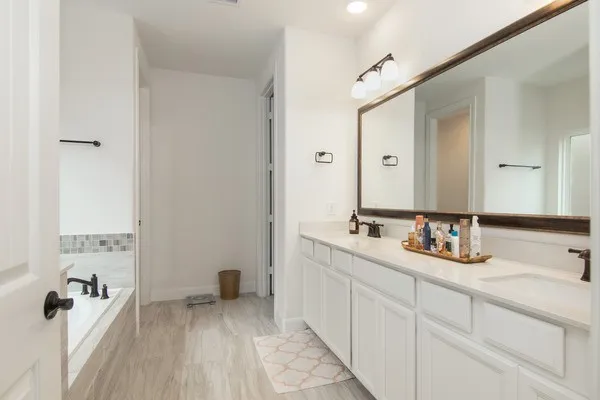 a bathroom with a bathtub and a sink