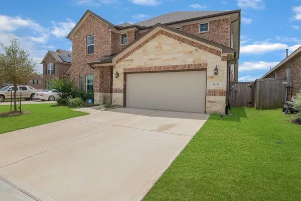 a view of a house with a yard and garage