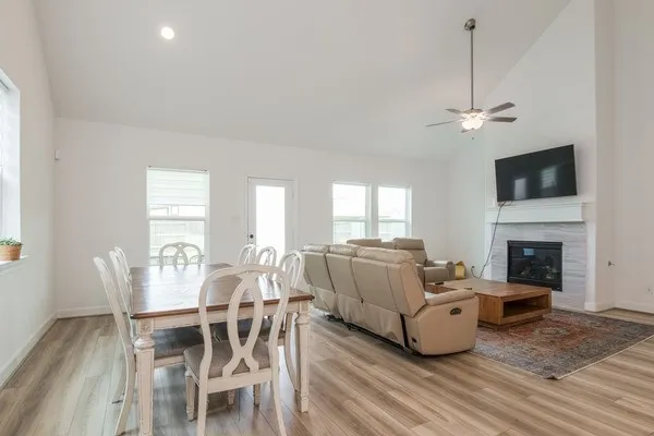 a living room with furniture a flat screen tv and a fireplace