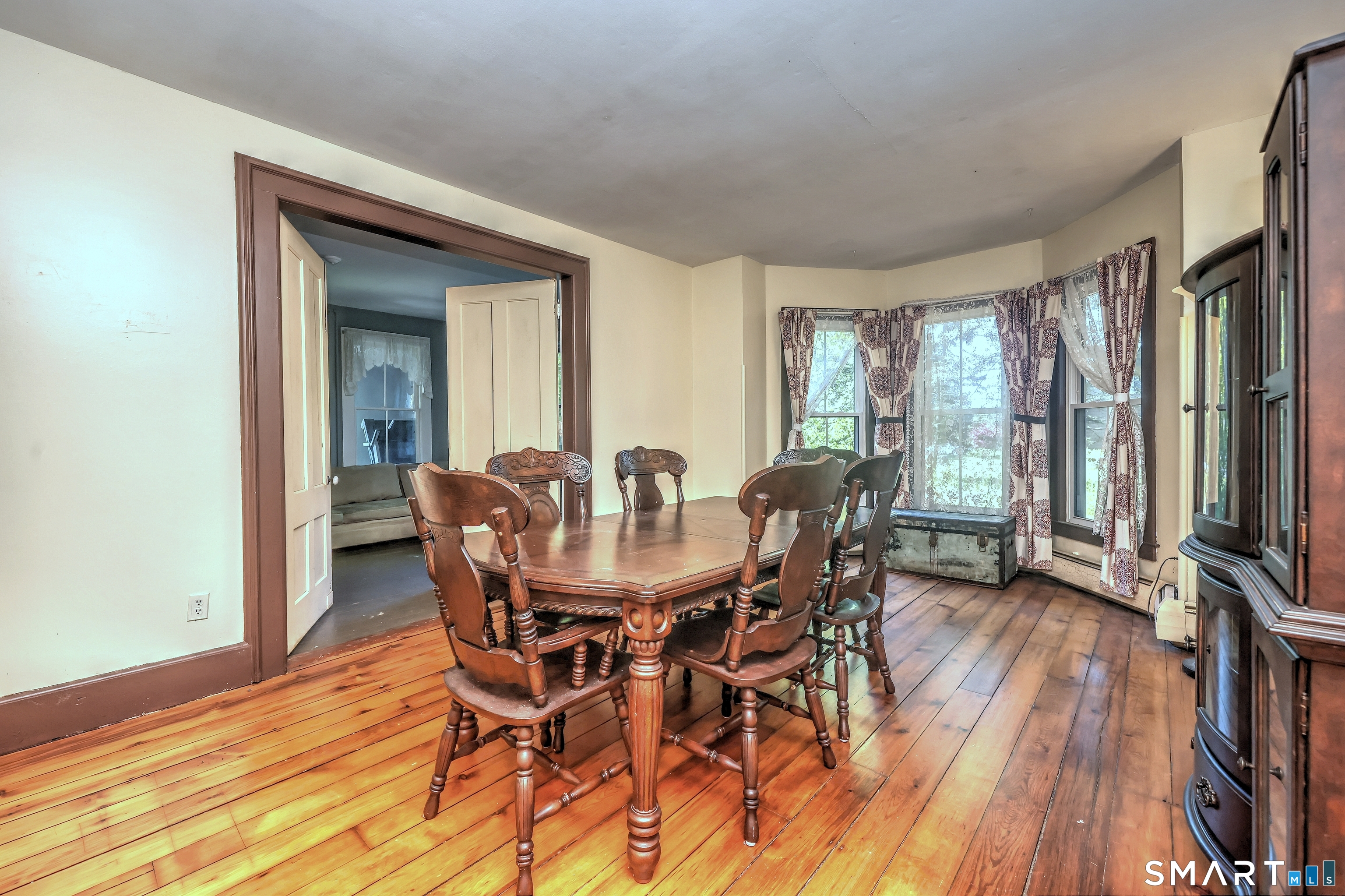 186 Jones Hill Road West Haven, CT 06516 - Photo 12 of 33 a view of a dining room with furniture and wooden floor