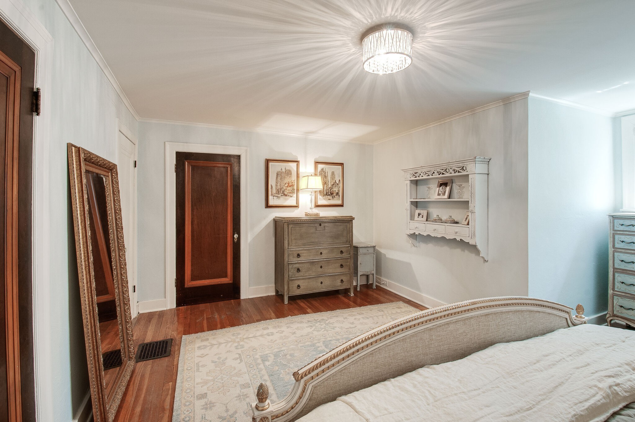 216 Cherokee Road Nashville, TN 37205 - Photo 32 of 39 a bedroom with a bed and a chandelier