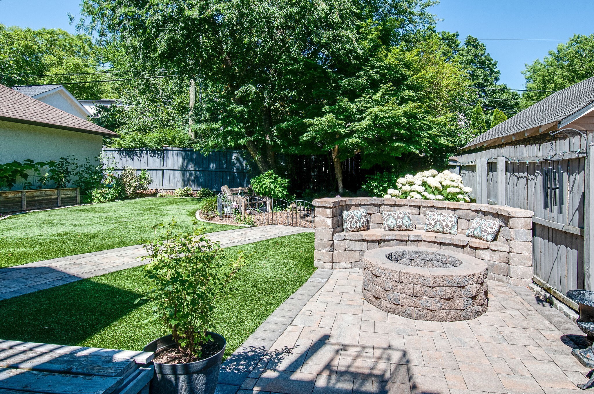216 Cherokee Road Nashville, TN 37205 - Photo 36 of 39 a view of a backyard with table and chairs potted plants and large tree