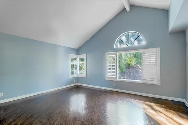 a room with a large window and furniture