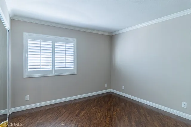 a view of a hallway with wooden floor and stairs