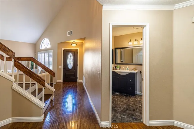 a view of a hallway view with wooden floor and staircase