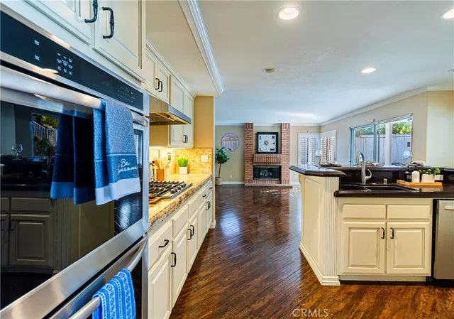 a kitchen with stainless steel appliances granite countertop a stove and cabinets
