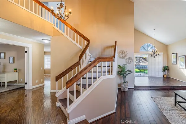 a living room with wooden floor and stairs