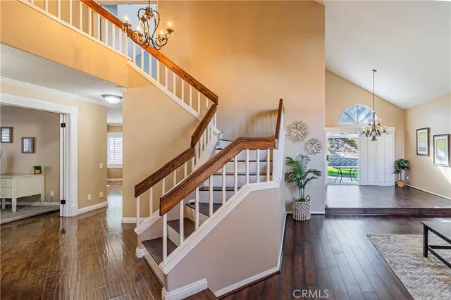 a living room with wooden floor and stairs