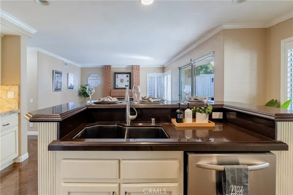 a kitchen with stainless steel appliances granite countertop a stove refrigerator sink and cabinets