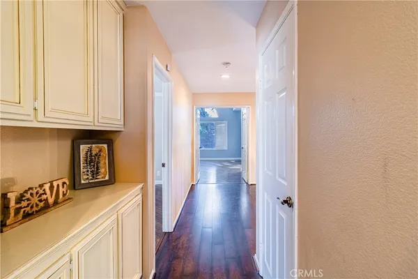a view of an empty room with closet and a window