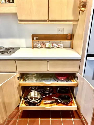 a bedroom with a bed and a refrigerator