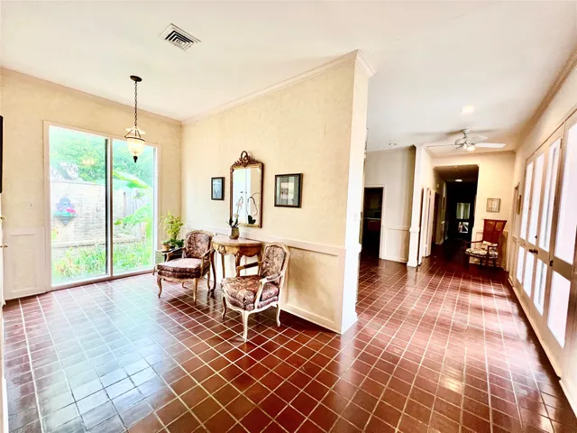 a living room with furniture rug and a floor to ceiling window