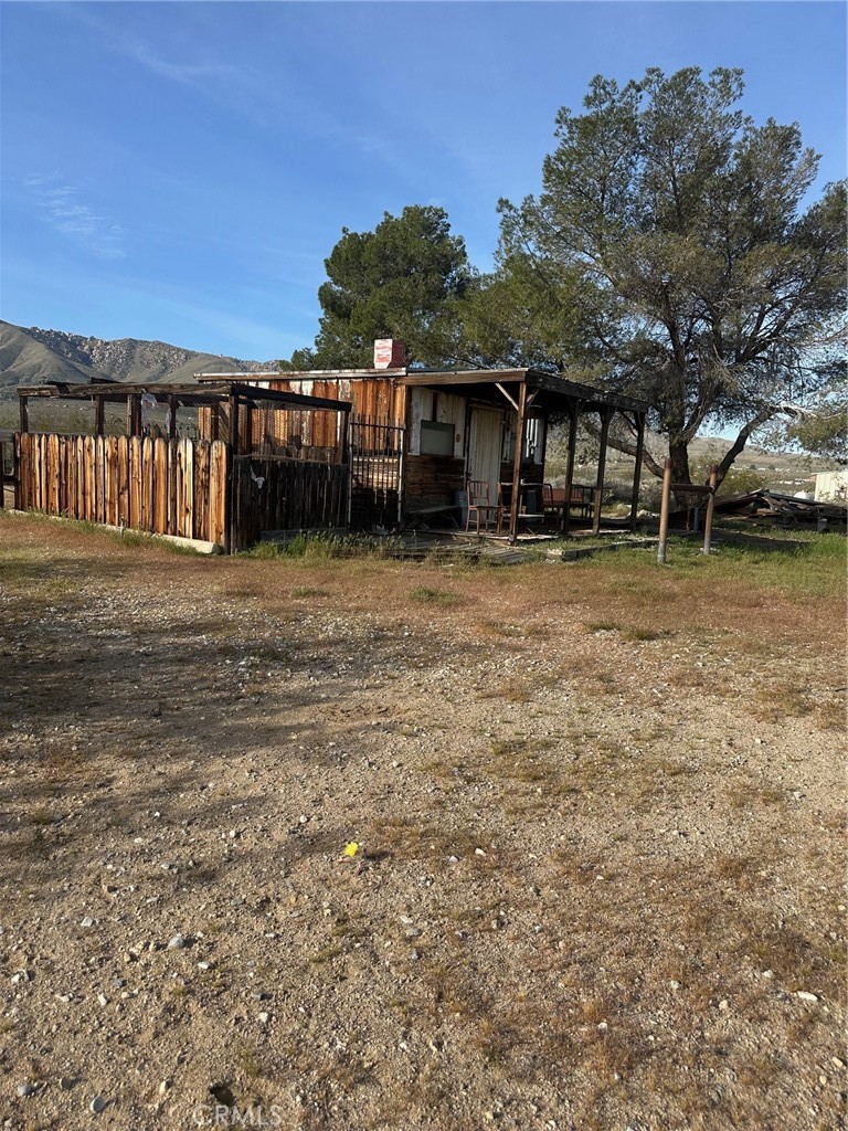 9772 Alamo Road Lucerne Valley, CA 92356 - Photo 13 of 24 a view of a house with a yard