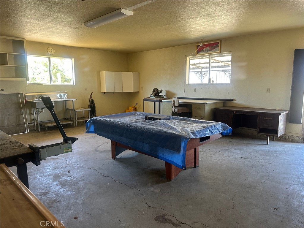 9772 Alamo Road Lucerne Valley, CA 92356 - Photo 19 of 24 a living room with furniture and a window