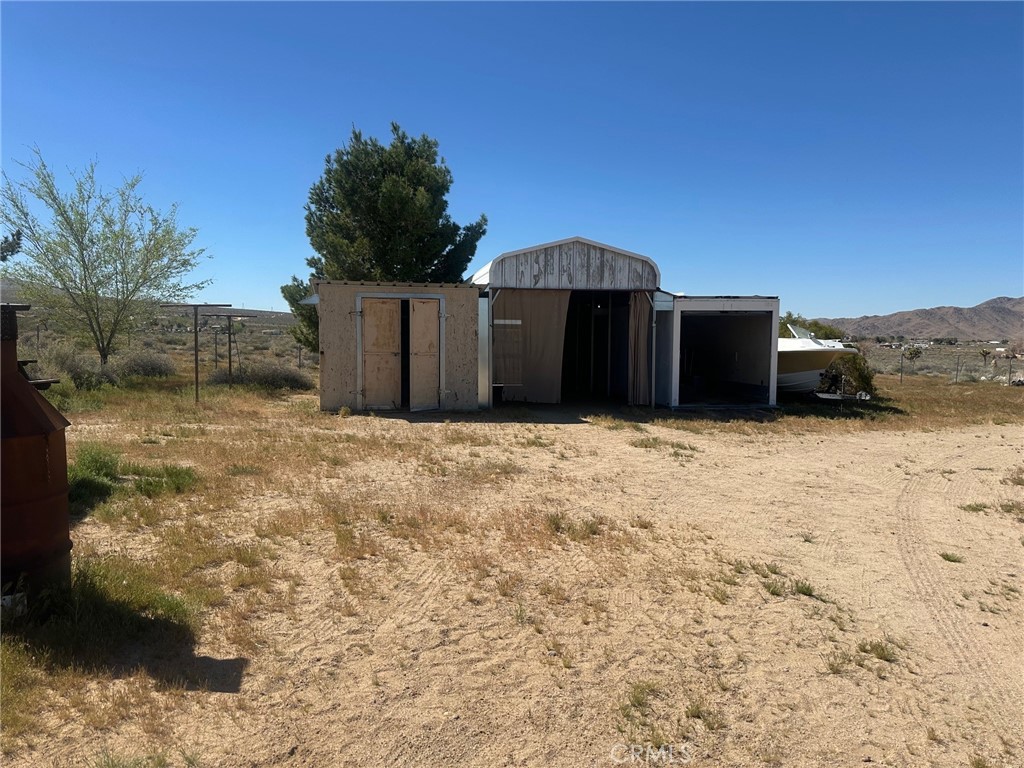9772 Alamo Road Lucerne Valley, CA 92356 - Photo 22 of 24 a front view of a house with a yard