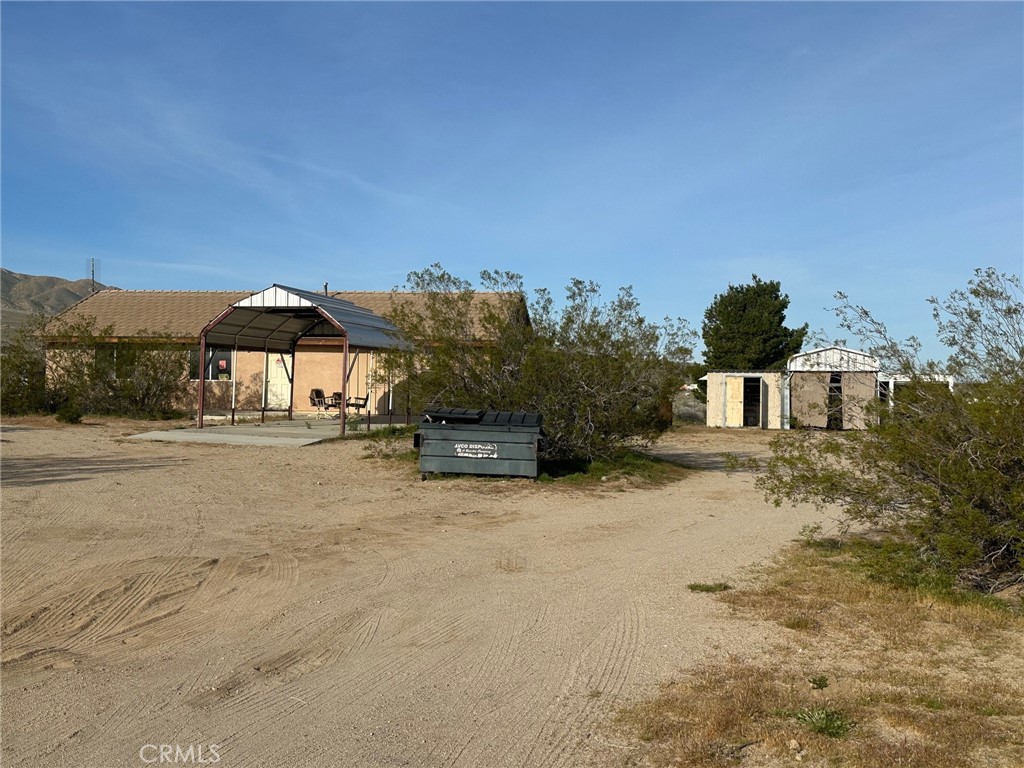 9772 Alamo Road Lucerne Valley, CA 92356 - Photo 3 of 24 a view of a house with a yard
