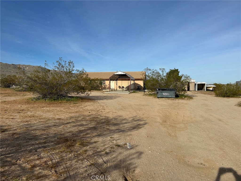 9772 Alamo Road Lucerne Valley, CA 92356 - Photo 4 of 24 a view of dirt road with a building in the background