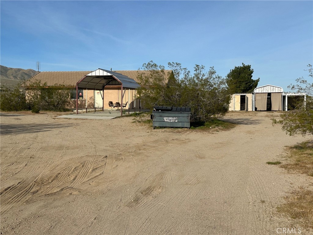 9772 Alamo Road Lucerne Valley, CA 92356 - Photo 5 of 24 a view of a house with a yard