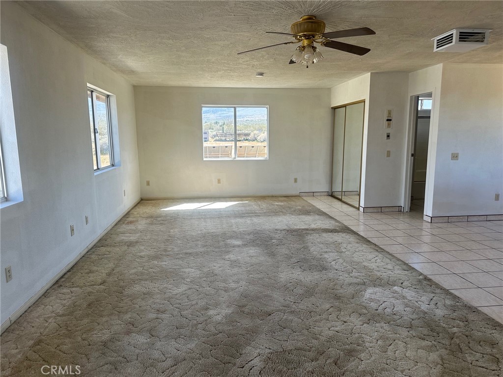 9772 Alamo Road Lucerne Valley, CA 92356 - Photo 9 of 24 a view of an empty room with a window