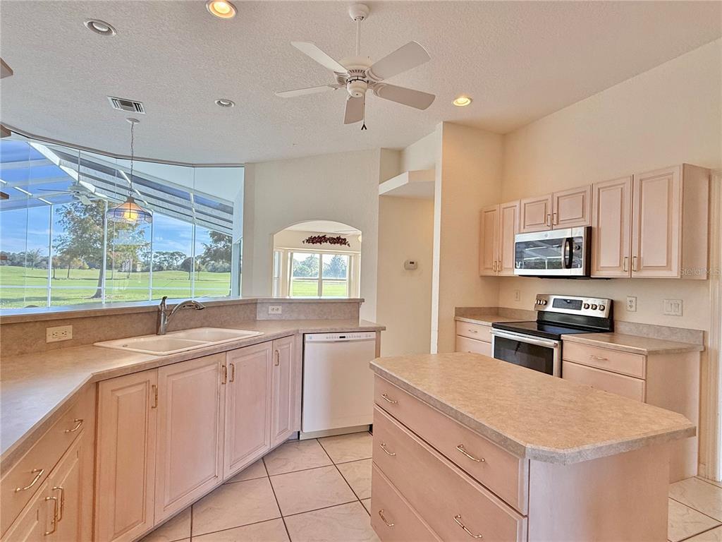 5614 Angelo Circle Sebring, FL 33872 - Photo 11 of 39 a kitchen with granite countertop a sink appliances cabinets and furniture