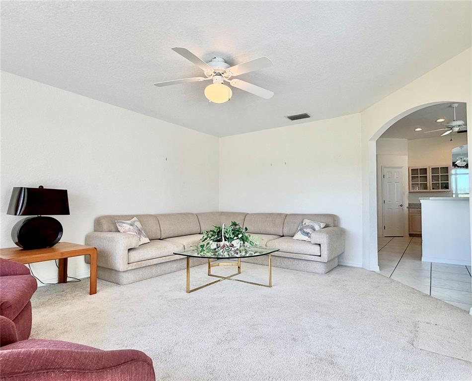 5614 Angelo Circle Sebring, FL 33872 - Photo 15 of 39 a living room with furniture and a chandelier
