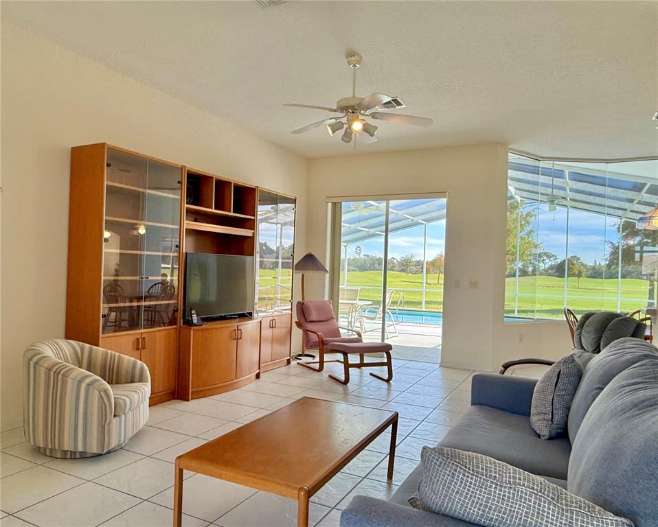 5614 Angelo Circle Sebring, FL 33872 - Photo 18 of 39 a living room with furniture and a flat screen tv