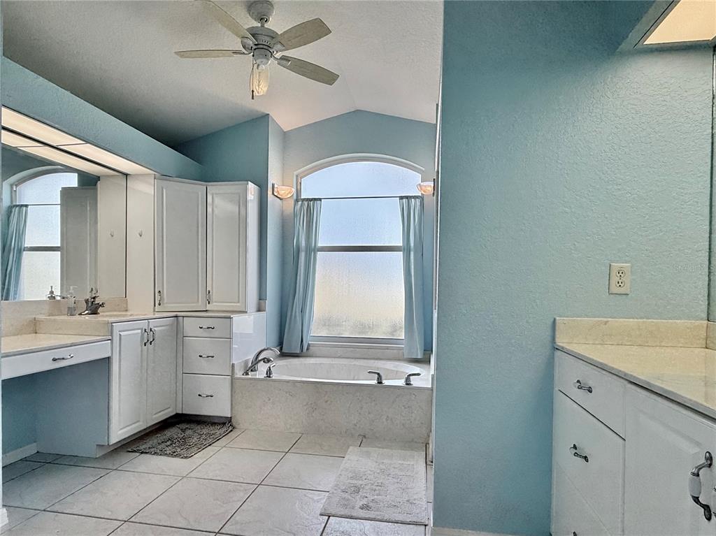 5614 Angelo Circle Sebring, FL 33872 - Photo 24 of 39 a bathroom with a sink a vanity and mirror