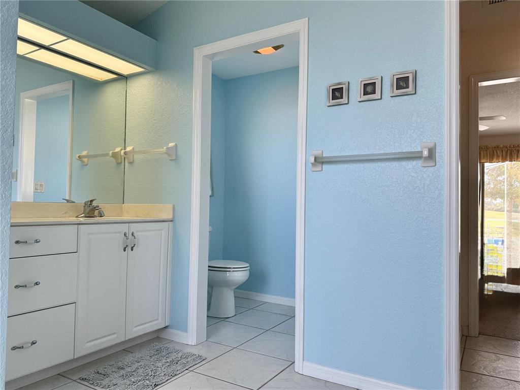 5614 Angelo Circle Sebring, FL 33872 - Photo 25 of 39 a spacious bathroom with a granite countertop sink toilet and shower