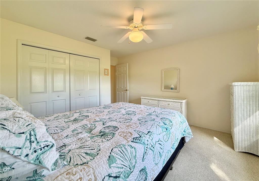 5614 Angelo Circle Sebring, FL 33872 - Photo 27 of 39 a bedroom with a bed and a chandelier