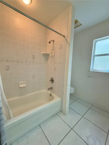 a spacious bathroom with a bathtub and a shower