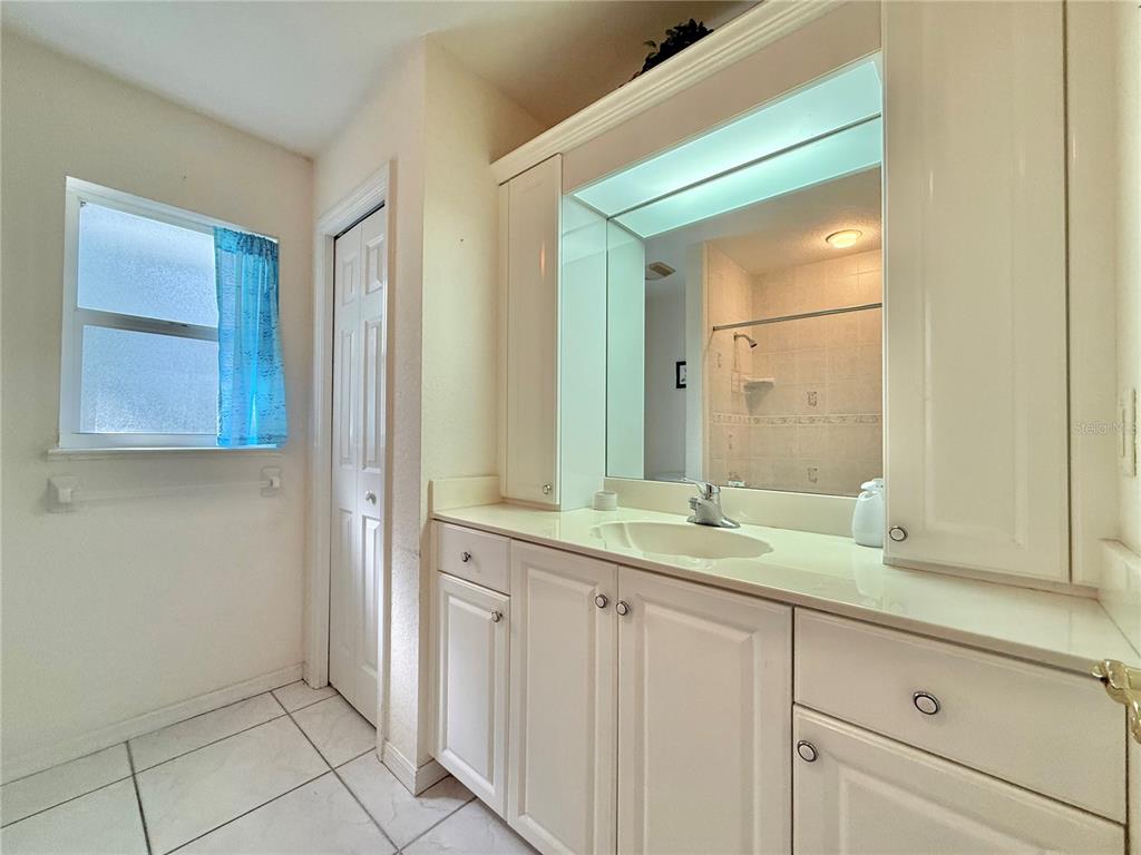 5614 Angelo Circle Sebring, FL 33872 - Photo 30 of 39 a bathroom with a granite countertop sink and a mirror