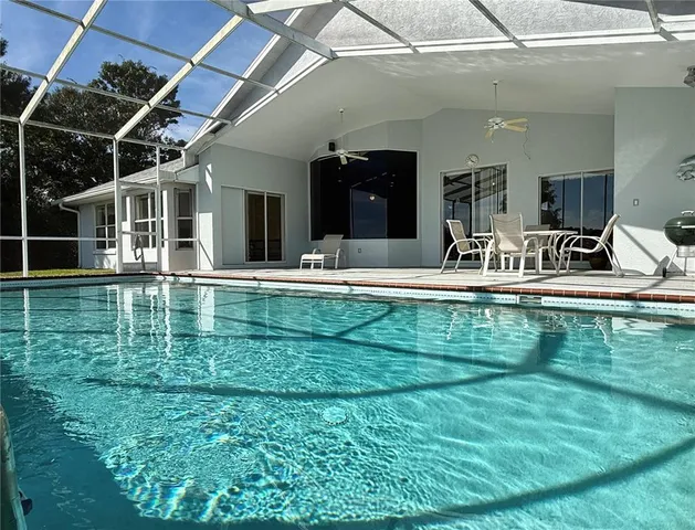 a house view with swimming pool outdoor seating and yard