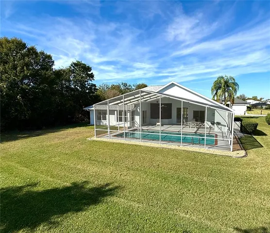 a house with swimming pool in front of it