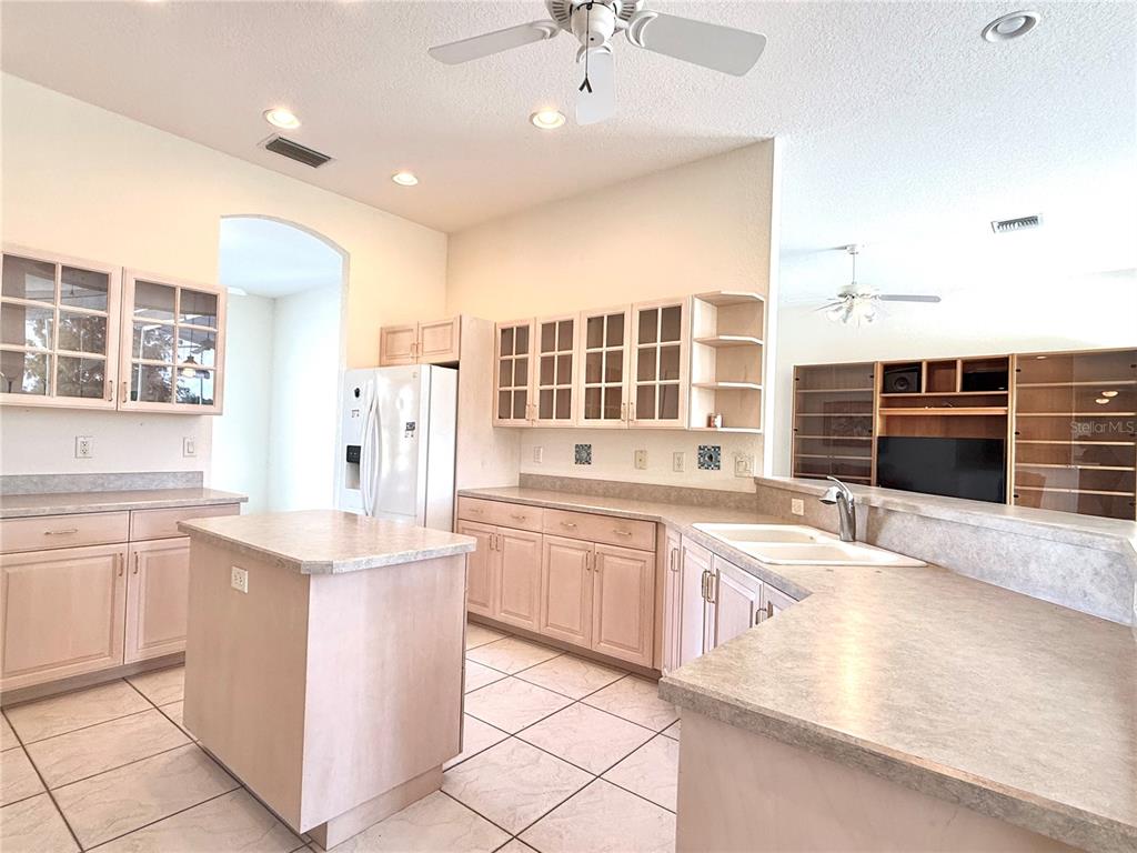 5614 Angelo Circle Sebring, FL 33872 - Photo 6 of 39 a large kitchen with kitchen island a sink stainless steel appliances and cabinets