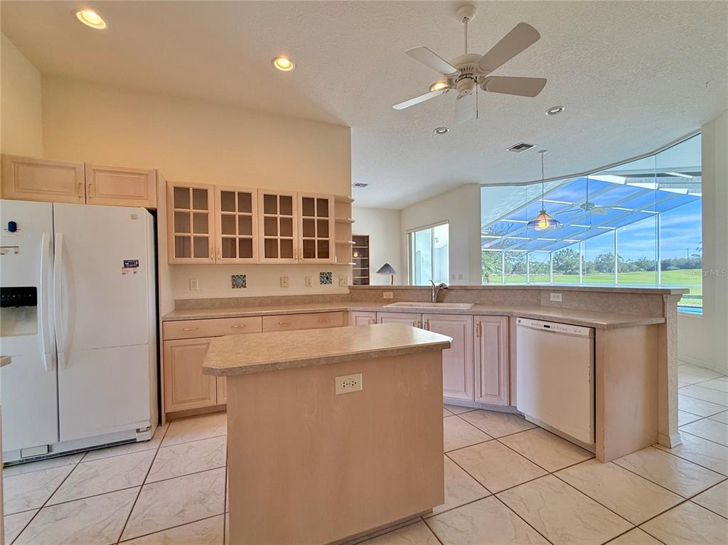 5614 Angelo Circle Sebring, FL 33872 - Photo 8 of 39 a kitchen with stainless steel appliances granite countertop a stove a refrigerator and a cabinets
