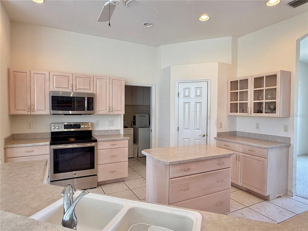 5614 Angelo Circle Sebring, FL 33872 - Photo 9 of 39 a kitchen with a sink stove and microwave