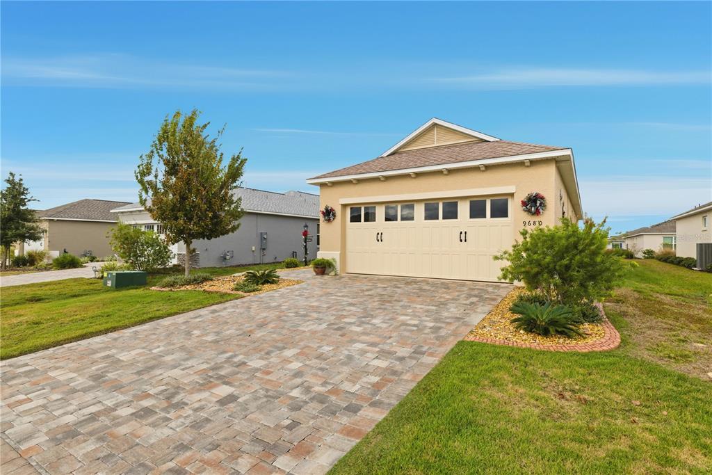 9680 Southwest 103rd Terrace Ocala, FL 34481 - Photo 1 of 24 a front view of a house with a yard