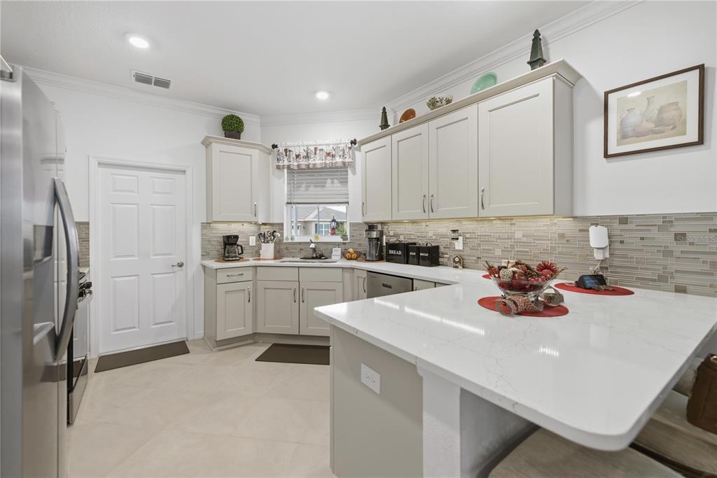 9680 Southwest 103rd Terrace Ocala, FL 34481 - Photo 12 of 24 a kitchen with refrigerator a sink and cabinets