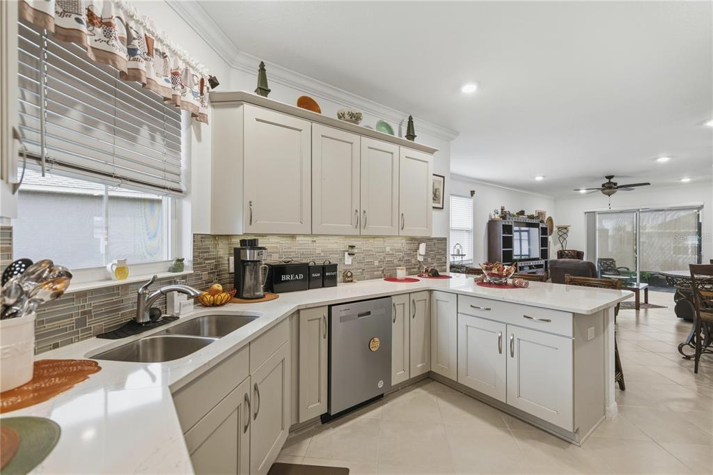 9680 Southwest 103rd Terrace Ocala, FL 34481 - Photo 14 of 24 a kitchen with a sink a stove and cabinets