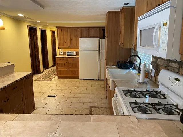 a kitchen with a refrigerator and a stove
