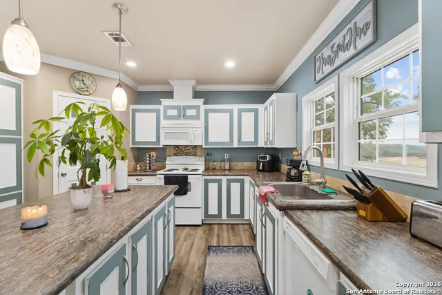 a kitchen that has a lot of cabinets in it