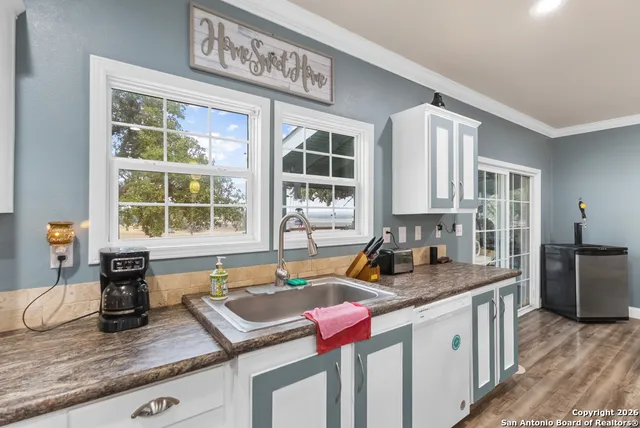 a kitchen with a granite countertop sink and window