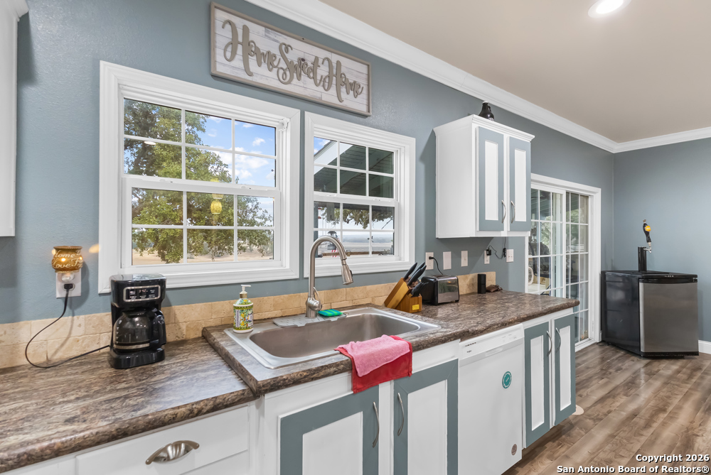 201 Private Road 1524 Bandera, TX 78003 - Photo 14 of 36 a kitchen with a granite countertop sink and window