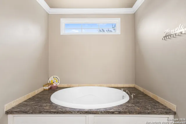 a bathroom with a granite countertop sink and vanity
