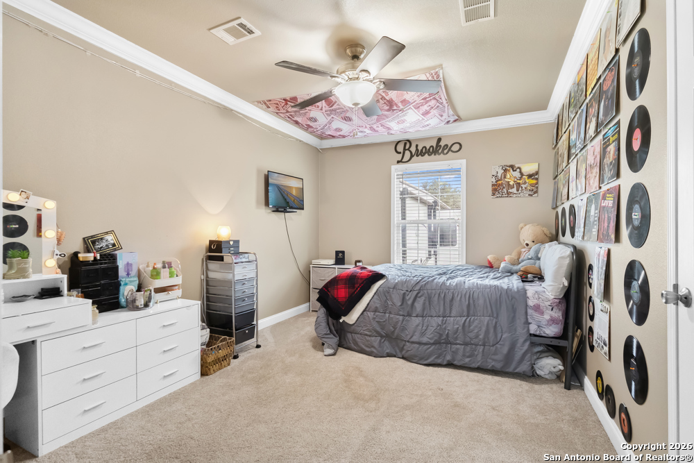 201 Private Road 1524 Bandera, TX 78003 - Photo 22 of 36 a bedroom with a bed and a chandelier