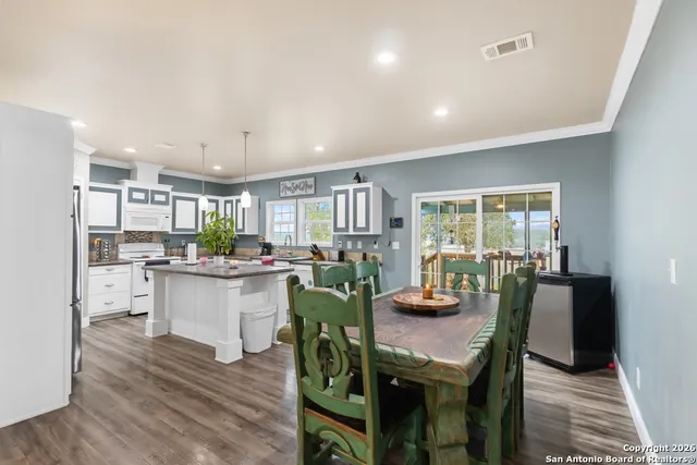 a kitchen with a table and chairs in it