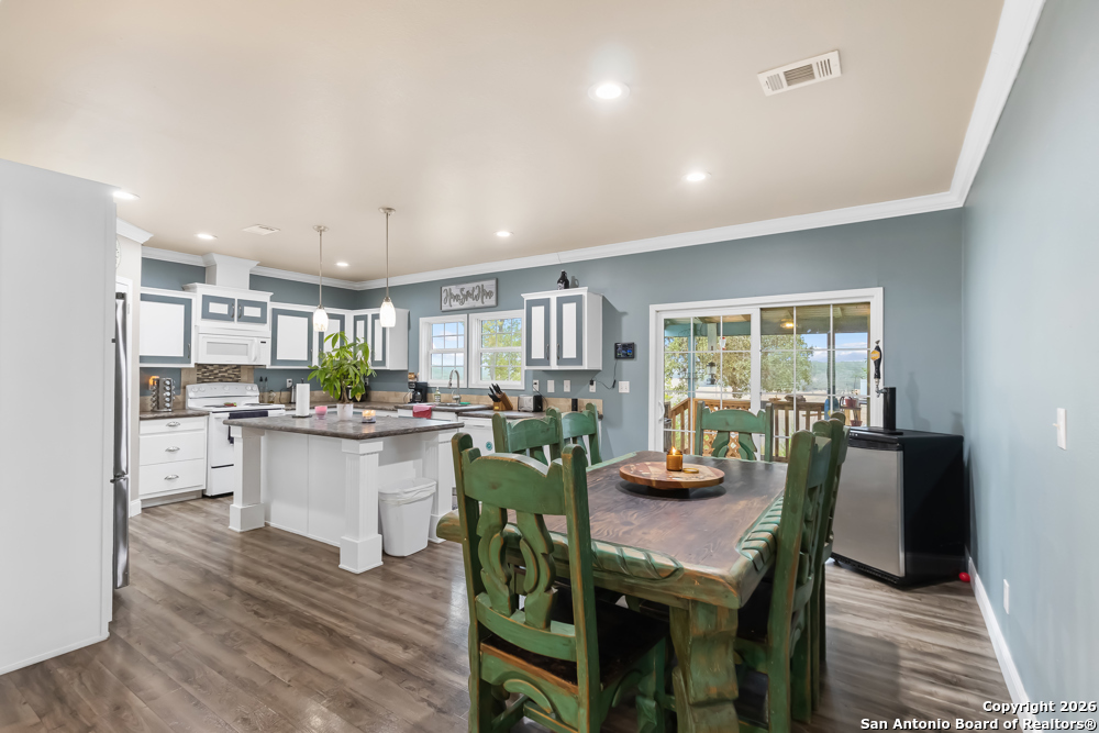 201 Private Road 1524 Bandera, TX 78003 - Photo 9 of 36 a kitchen with a table and chairs in it